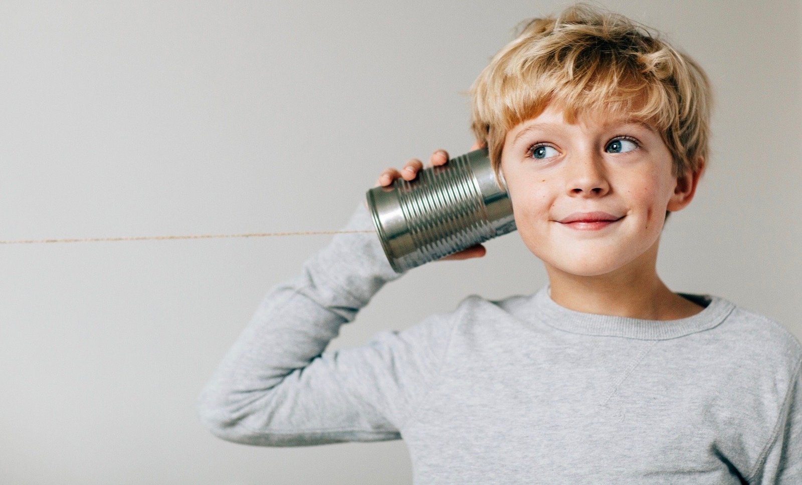 Boy listens to Tin Can Phone 1.jpg